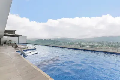 a swimming pool with a view of a city at Cityscape iFreses, 20th floor! AC, TV and Pool in Guayabos