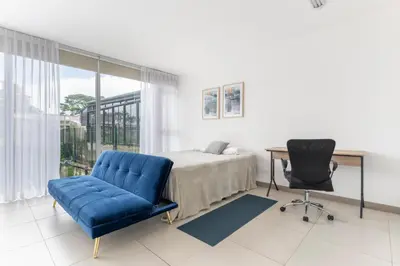a bedroom with a bed and a desk and a chair at Vista Verde iFreses, 2nd floor! AC, TV and Pool in Guayabos