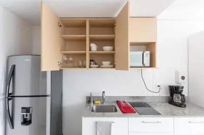 a kitchen with a refrigerator and a sink at Vista Verde iFreses, 2nd floor! AC, TV and Pool in Guayabos
