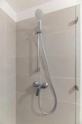 a shower with a shower head in a bathroom at Vista Verde iFreses, 2nd floor! AC, TV and Pool in Guayabos