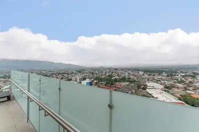 a view of a city from the top of a building at Vista Verde iFreses, 2nd floor! AC, TV and Pool in Guayabos