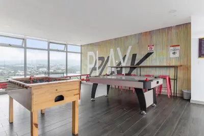 two ping pong tables in a room with a mural at Modern Oasis iFreses, 18th floor! AC, TV and Pool in Guayabos