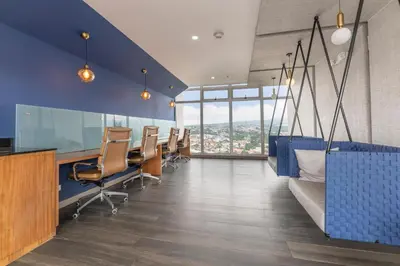 an office with a row of chairs and blue walls at Modern Oasis iFreses, 18th floor! AC, TV and Pool in Guayabos