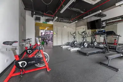 a gym with several bikes parked in a room at Modern Oasis iFreses, 18th floor! AC, TV and Pool in Guayabos