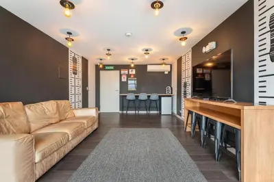 a living room with a couch and a bar at Urban Vista iFreses, 2nd floor! AC, TV and Pool in Guayabos