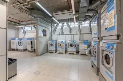 a laundry room with several washers and dryers at Urban Vista iFreses, 2nd floor! AC, TV and Pool in Guayabos