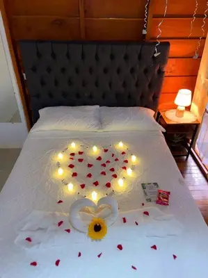 a bed with a heart made out of hearts and lights at Cabaña Luna Arenal in Fortuna