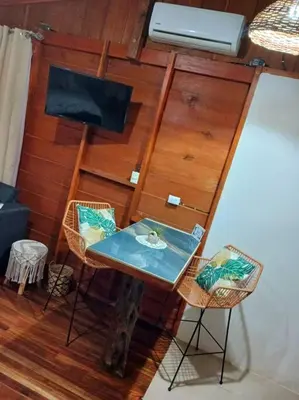 a small table and two chairs in a room at Cabaña Luna Arenal in Fortuna