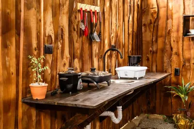 a kitchen with a counter with a stove and a sink at Rousse Cabin in Rivas
