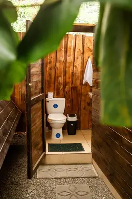 a bathroom with a toilet in a wooden structure at Rousse Cabin in Rivas