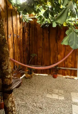 a wooden fence with a hose next to some plants at Rousse Cabin in Rivas