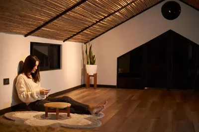 a woman sitting on the floor in a living room at Villa Natura in Bajos del Toro