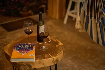 a bottle of wine and two wine glasses on a table at Villa Natura in Bajos del Toro