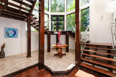 a room with a spiral staircase and a table at Golf from home! 8BR Lux Villa, Pool, Beach Club! in Playa Avellana