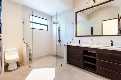 a bathroom with a glass shower and a toilet at Golf from home! 8BR Lux Villa, Pool, Beach Club! in Playa Avellana