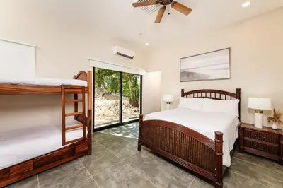 a bedroom with two bunk beds and a window at Golf from home! 8BR Lux Villa, Pool, Beach Club! in Playa Avellana