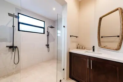 a bathroom with a shower and a sink and a mirror at Golf from home! 8BR Lux Villa, Pool, Beach Club! in Playa Avellana