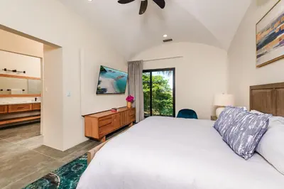 a bedroom with a large white bed and a dresser at Golf from home! 8BR Lux Villa, Pool, Beach Club! in Playa Avellana
