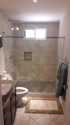 a bathroom with a shower with a toilet and a sink at #17A Hermosa Beach Bungalow 1st floor 1 bedroom Apt in Playa Hermosa