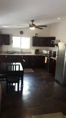 a kitchen with a table and a ceiling fan at #17A Hermosa Beach Bungalow 1st floor 1 bedroom Apt in Playa Hermosa