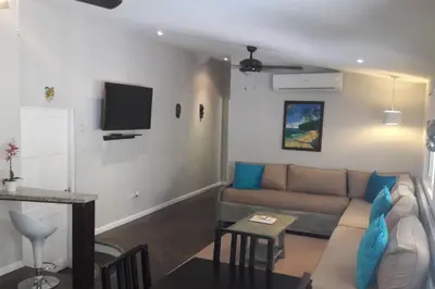 a living room with a couch and a tv at #17A Hermosa Beach Bungalow 1st floor 1 bedroom Apt in Playa Hermosa