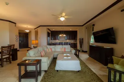 a living room with a couch and a tv at Vista Bahia 1G 3 bdr Ocean View in Los Suenos in Herradura