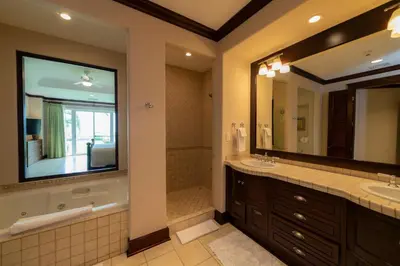 a bathroom with two sinks and a large mirror at Vista Bahia 1G 3 bdr Ocean View in Los Suenos in Herradura