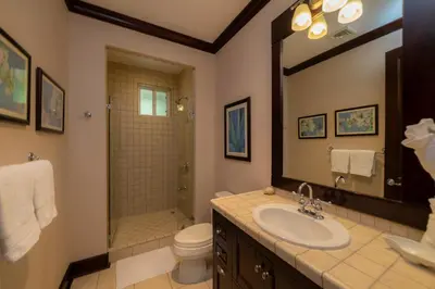a bathroom with a sink and a toilet and a shower at Vista Bahia 1G 3 bdr Ocean View in Los Suenos in Herradura