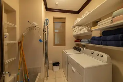 a laundry room with a washing machine and a shower at Vista Bahia 1G 3 bdr Ocean View in Los Suenos in Herradura