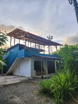 a small house with a roof on top of it at Alma Del Bosque Hotel in Tortuguero