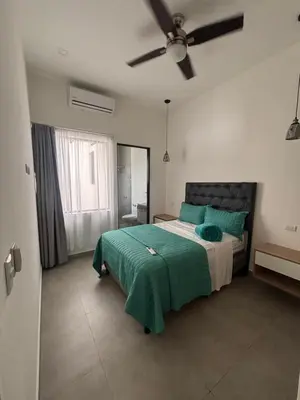 a bedroom with a bed and a ceiling fan at Casa Yani Santa teresa in San Isidro