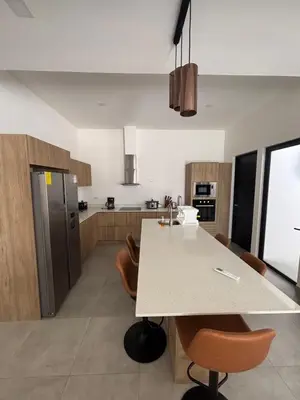 a kitchen with a table and chairs in a room at Casa Yani Santa teresa in San Isidro