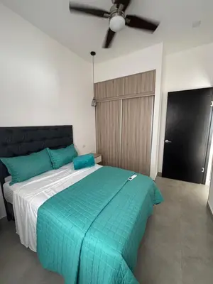 a bedroom with a large bed with a green comforter at Casa Yani Santa teresa in San Isidro