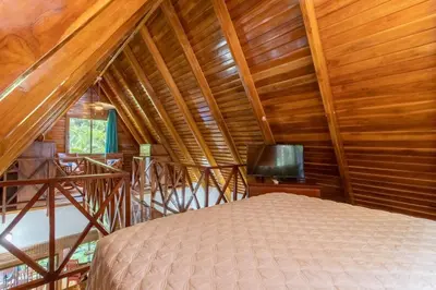 a bedroom with a bed and a wooden ceiling at Namaste Beach Bungalow 1 BDR Loft 4 Min to Beach in Nosara