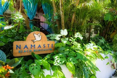a sign that says namaste beach kingdom in a garden at Namaste Beach Bungalow 1 BDR Loft 4 Min to Beach in Nosara