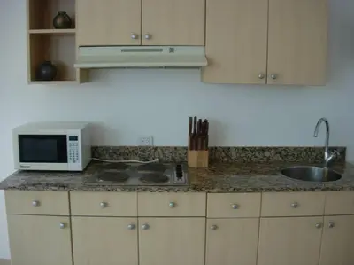 a kitchen counter with a microwave and a sink at A5 PL Near the beach 1bed 1 office 1 bathroom in Tamarindo
