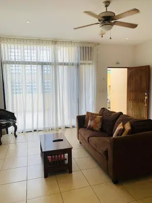 a living room with a couch and a coffee table at A5 PL Near the beach 1bed 1 office 1 bathroom in Tamarindo