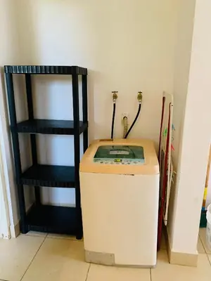 a corner of a room with a heater and a shelf at A5 PL Near the beach 1bed 1 office 1 bathroom in Tamarindo