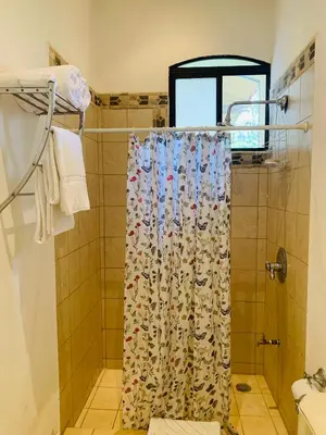 a shower with a shower curtain in a bathroom at A5 PL Near the beach 1bed 1 office 1 bathroom in Tamarindo