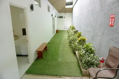 a corridor of a building with a green carpeted hallway at Cabinas La Sirena in Puntarenas