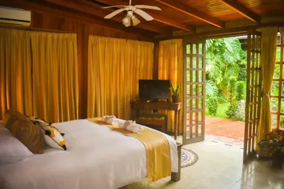 a bedroom with a bed and a television in it at Turrialba Bed & Breakfast in Turrialba
