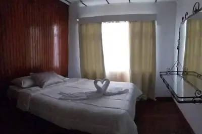 a bedroom with a bed with a heart carved on it at Aurora Retreat Costa Rica in Tilarán