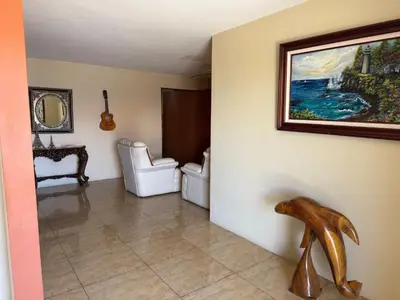 a living room with a painting on the wall at Aurora Retreat Costa Rica in Tilarán