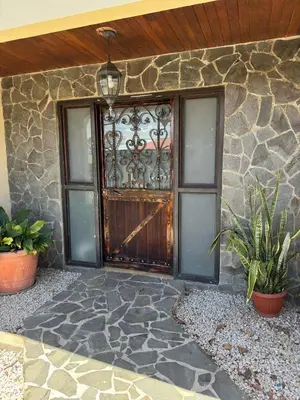 a front door of a house with potted plants at Aurora Retreat Costa Rica in Tilarán