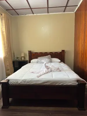 a bed with pink clothes on it in a bedroom at Aurora Retreat Costa Rica in Tilarán