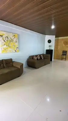 a living room with two couches and a painting on the wall at Casita Verde in Uvita
