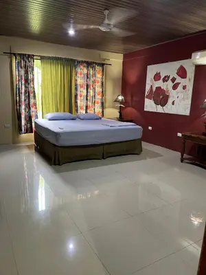 a bedroom with a bed in the middle of a room at Casita Verde in Uvita