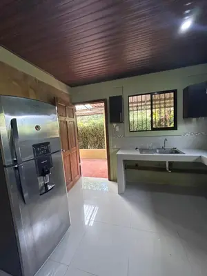 a kitchen with a stainless steel refrigerator and a sink at Casita Verde in Uvita