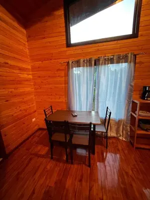 a dining room with a table and chairs and a window at Seahorse Breeze Apartment 1 in Uvita