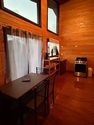 a dining room with a table and chairs and a kitchen at Seahorse Breeze Apartment 1 in Uvita